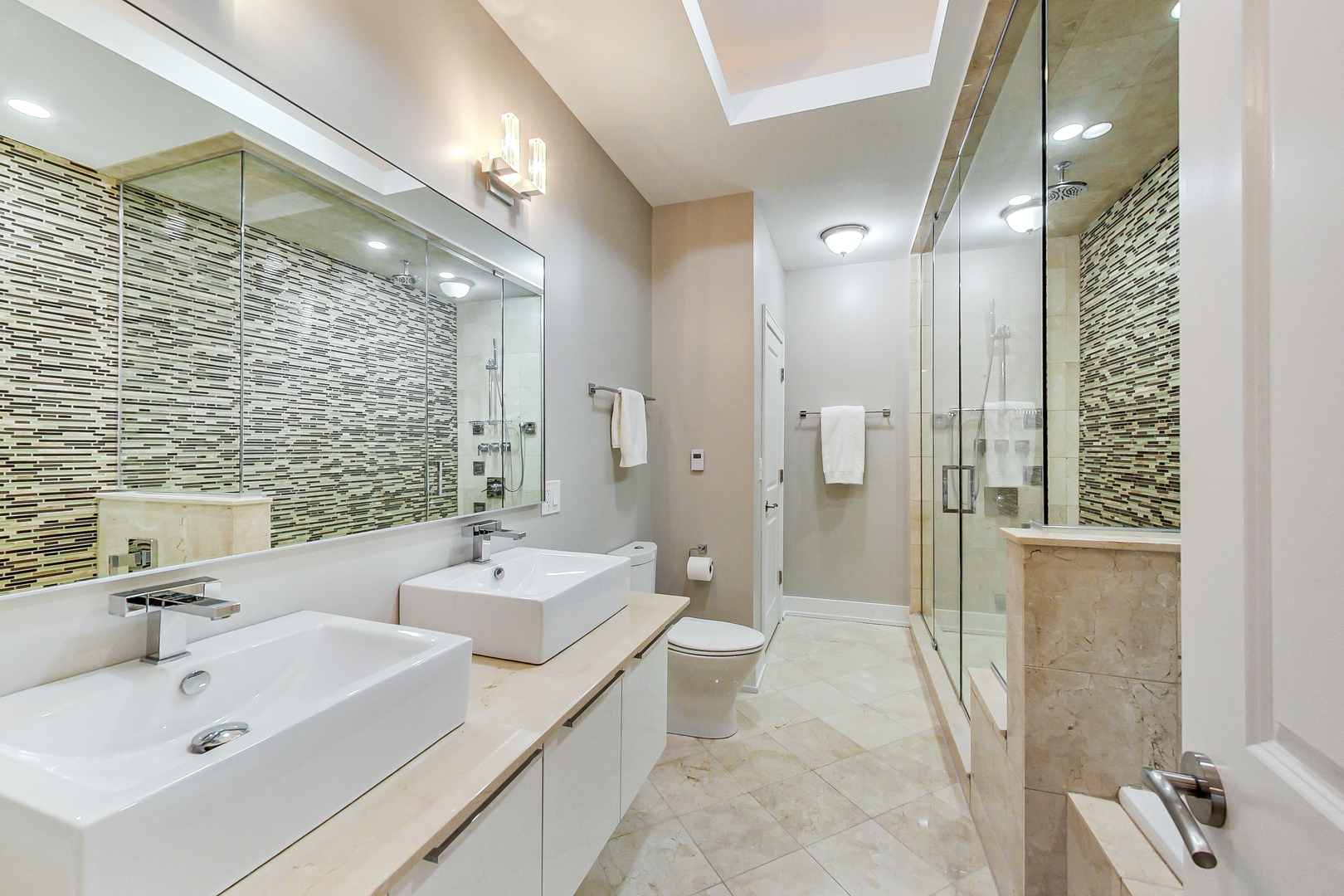 2121 West Roscoe Street, Unit 2 Chicago, IL 60618 - Photo 17 of 24 a bathroom with a double vanity sink mirror and shower