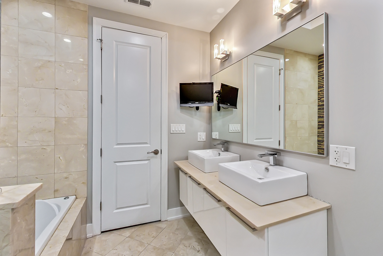 2121 West Roscoe Street, Unit 2 Chicago, IL 60618 - Photo 19 of 24 a bathroom with a sink and a mirror