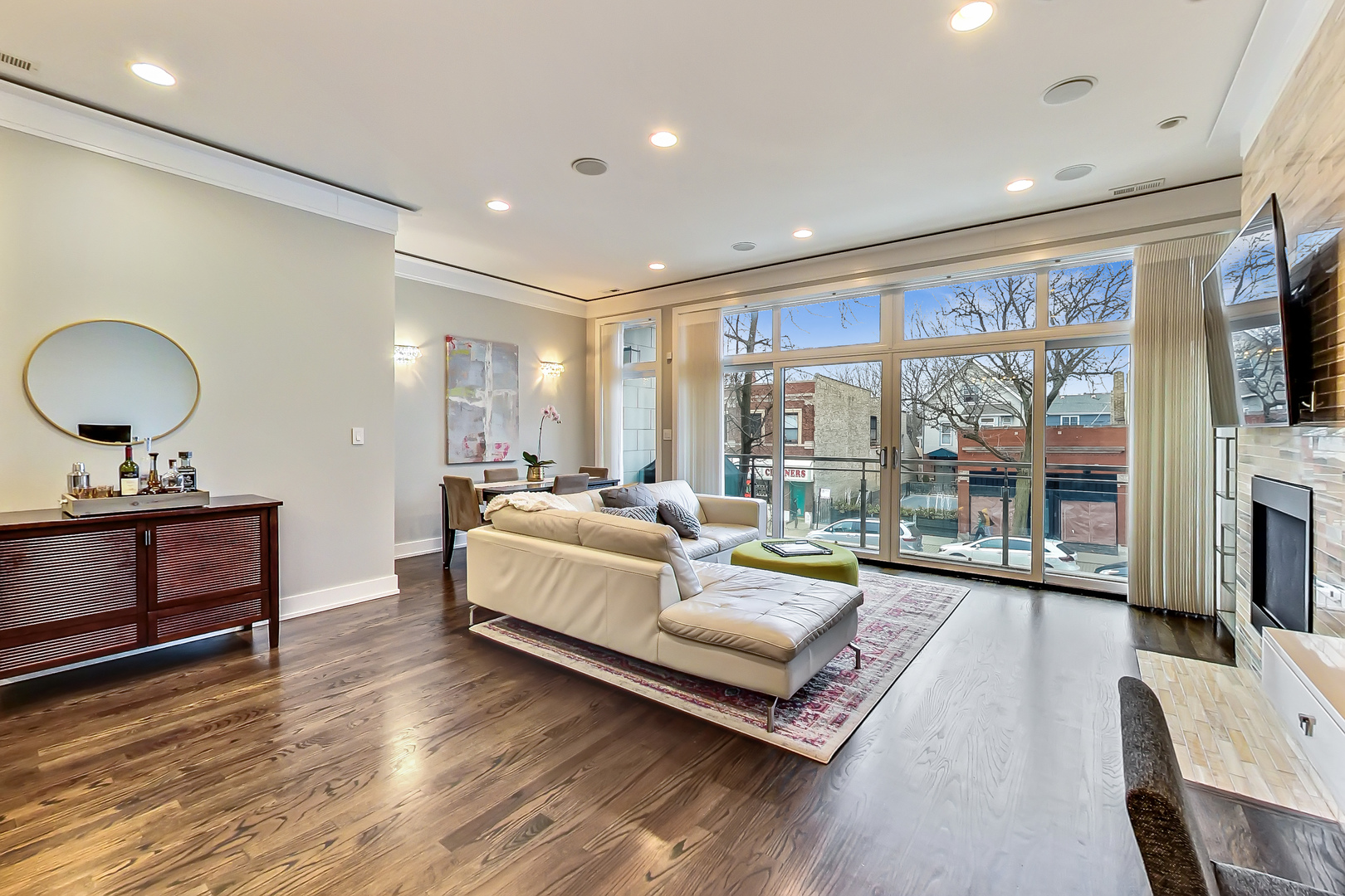 2121 West Roscoe Street, Unit 2 Chicago, IL 60618 - Photo 3 of 24 a living room with furniture and a flat screen tv