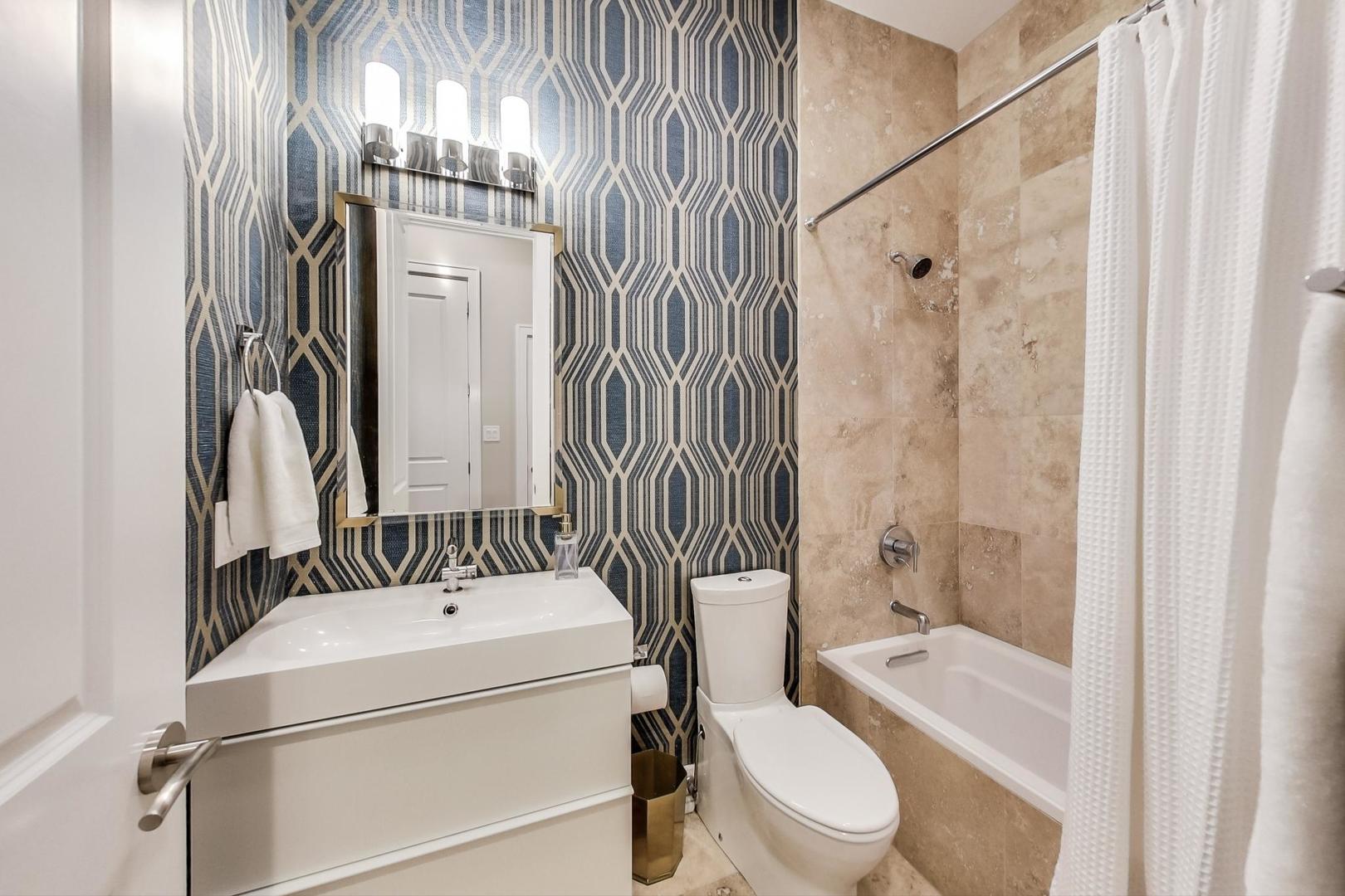 2121 West Roscoe Street, Unit 2 Chicago, IL 60618 - Photo 22 of 24 a bathroom with a sink a toilet and shower