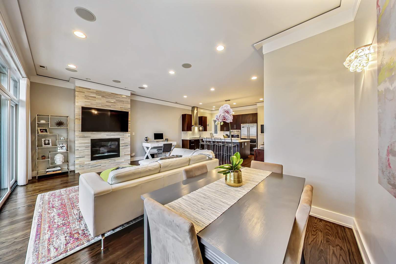 2121 West Roscoe Street, Unit 2 Chicago, IL 60618 - Photo 7 of 24 a living room with stainless steel appliances furniture a rug and a flat screen tv