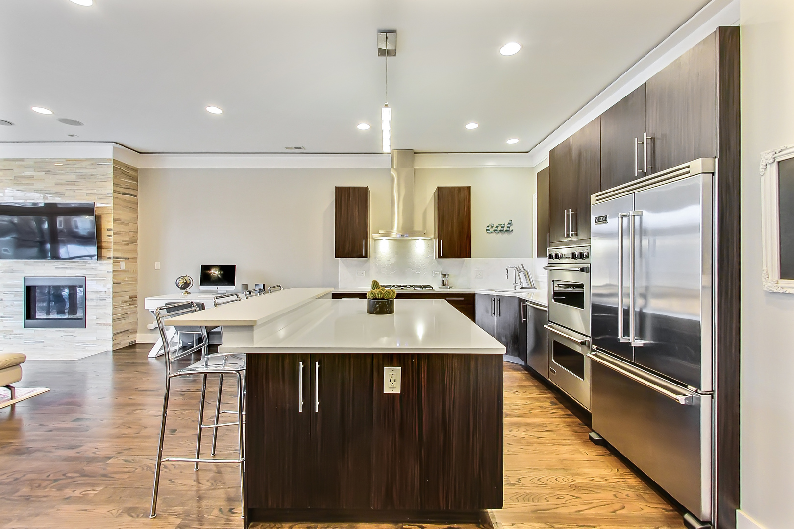 2121 West Roscoe Street, Unit 2 Chicago, IL 60618 - Photo 9 of 24 a large kitchen with kitchen island a large counter top stainless steel appliances and cabinets