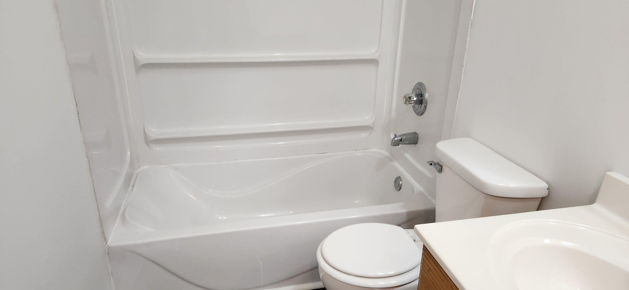 722-1 Capitol Road Valparaiso, IN 46385 - Photo 9 of 12 a white toilet sitting next to a bath tub