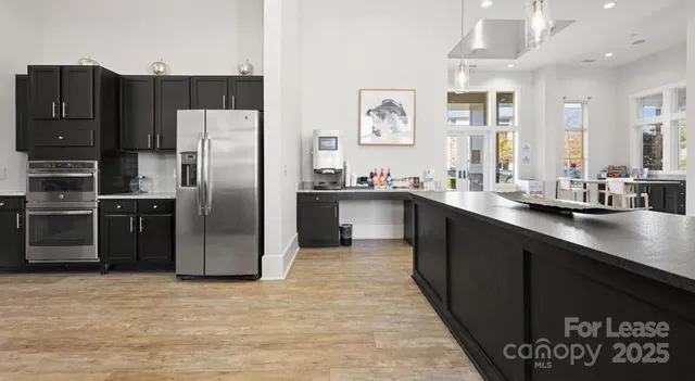 a kitchen with granite countertop a refrigerator and a sink