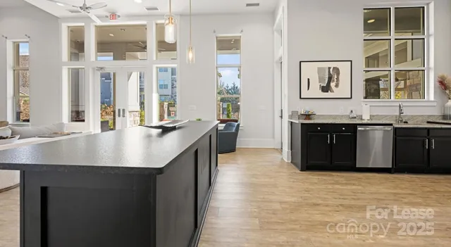 a large kitchen with stainless steel appliances granite countertop a sink and cabinets