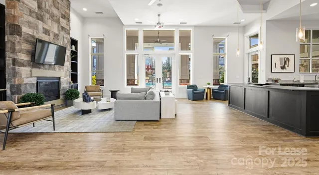 a living room with furniture large window and flat screen tv