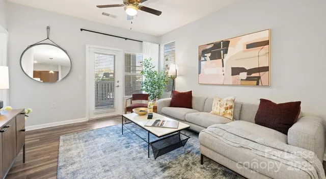 a living room with furniture and a mirror