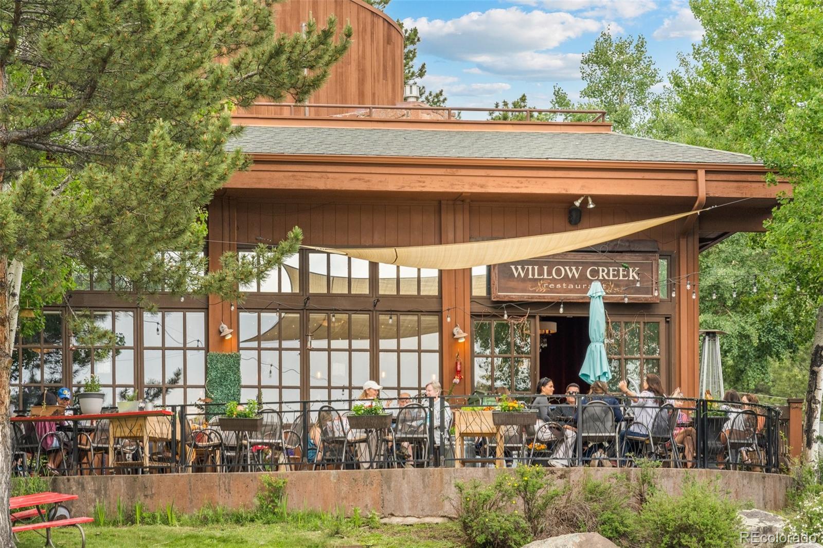 34095 Columbine Circle Evergreen, CO 80439 - Photo 28 of 32 a view of a house with sitting area and garden