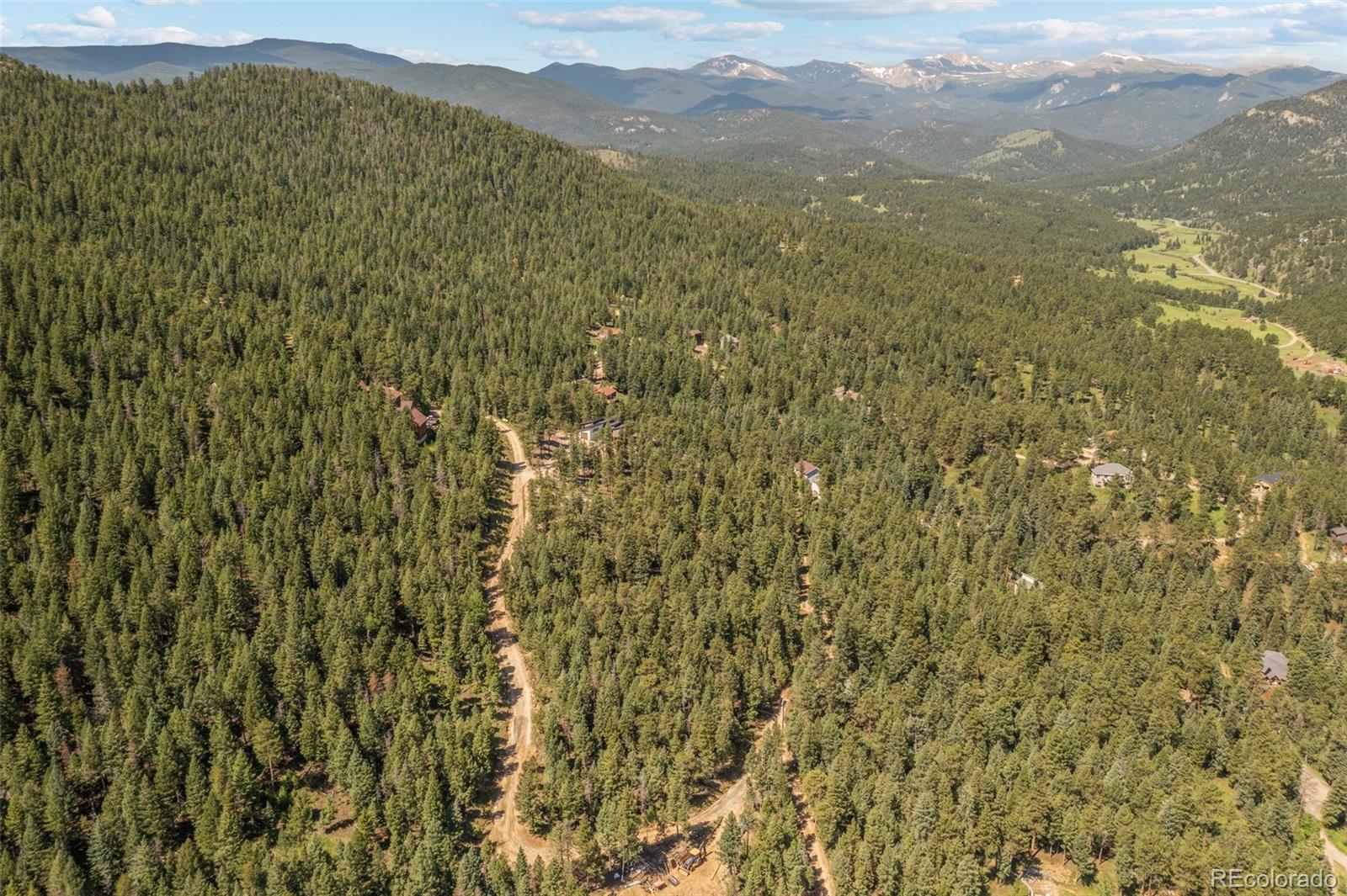 34095 Columbine Circle Evergreen, CO 80439 - Photo 6 of 32 a view of a field with a mountain in the background