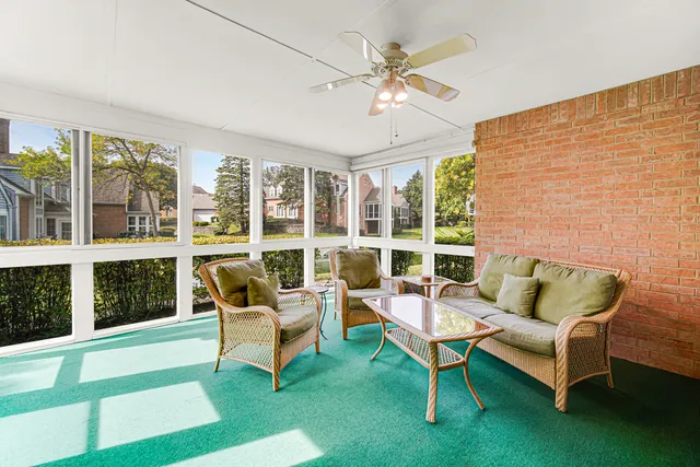 a living room with furniture and large windows
