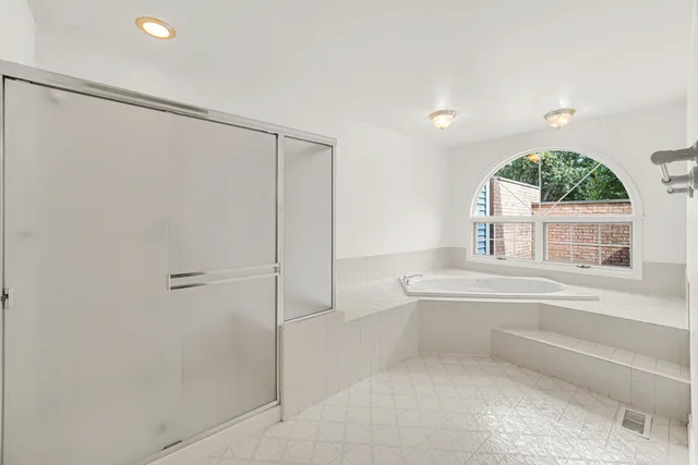 a spacious bathroom with a double vanity sink mirror and double