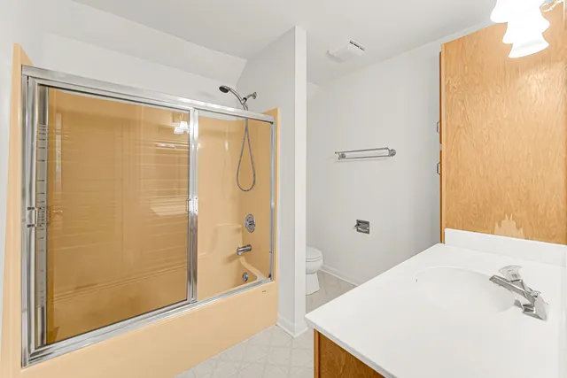 a bathroom with a sink a toilet and mirror