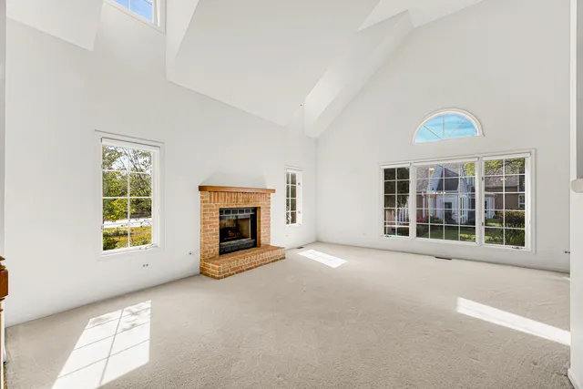 an empty room with furniture and a fireplace