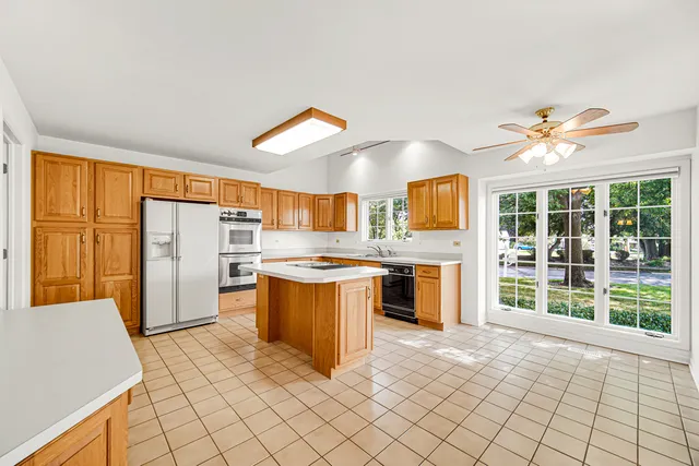 a kitchen with stainless steel appliances granite countertop a sink and a stove