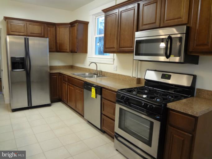 644 Coleraine Road Baltimore, MD 21229 - Photo 14 of 30 a kitchen with granite countertop a sink stove and refrigerator