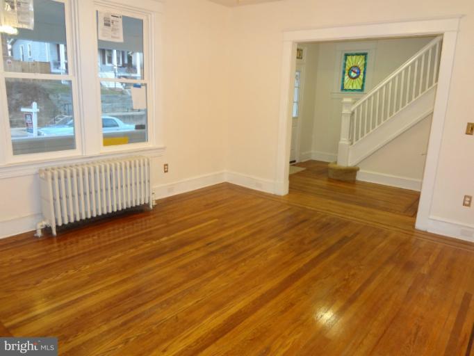 644 Coleraine Road Baltimore, MD 21229 - Photo 23 of 30 a view of a hallway with wooden floor and windows