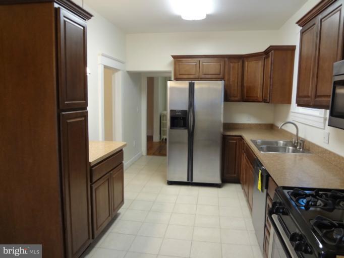 644 Coleraine Road Baltimore, MD 21229 - Photo 7 of 30 a kitchen with stainless steel appliances granite countertop a refrigerator and a sink