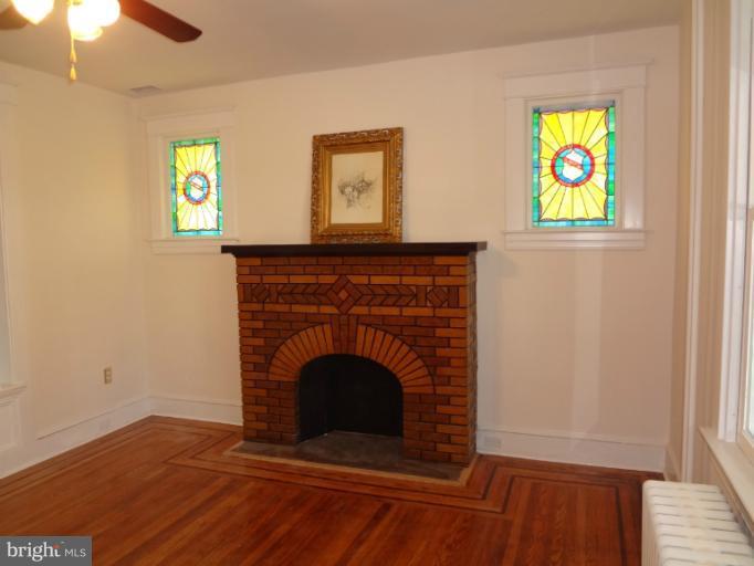 644 Coleraine Road Baltimore, MD 21229 - Photo 10 of 30 a view of an empty room with window and wooden floor