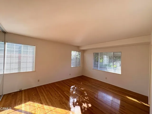 a view of a room with wooden floor and window