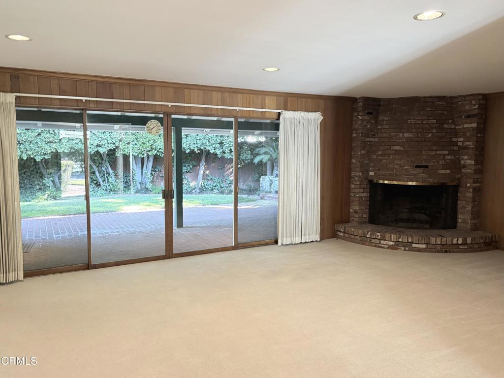 1920 North Altadena Drive Pasadena, CA 91107 - Photo 2 of 25 a view of an empty room with a fireplace and a window