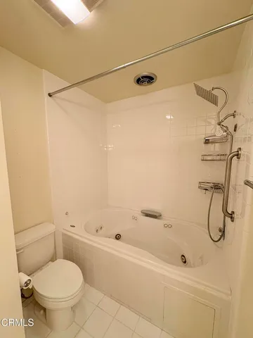 a bathroom with a shower a toilet and a shower