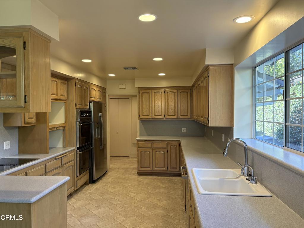 1920 North Altadena Drive Pasadena, CA 91107 - Photo 9 of 25 a large hall with stainless steel appliances granite countertop a sink and a refrigerator