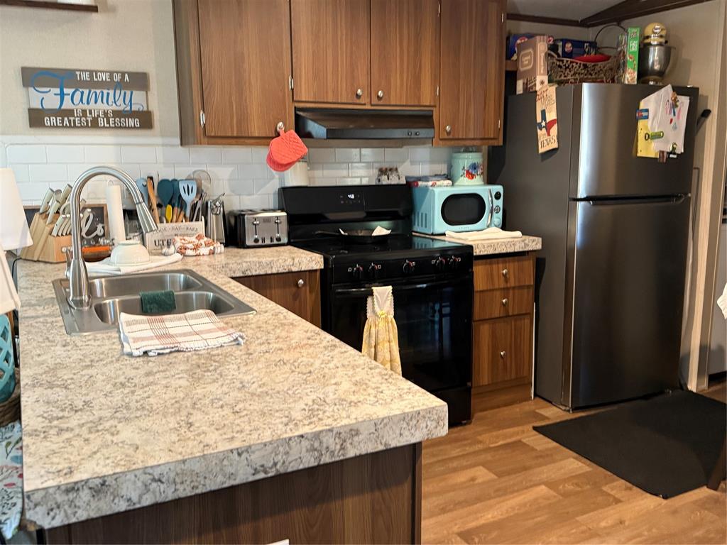 233 Overland Trail Jacksboro, TX 76458 - Photo 4 of 10 a kitchen with stainless steel appliances granite countertop a sink stove and refrigerator
