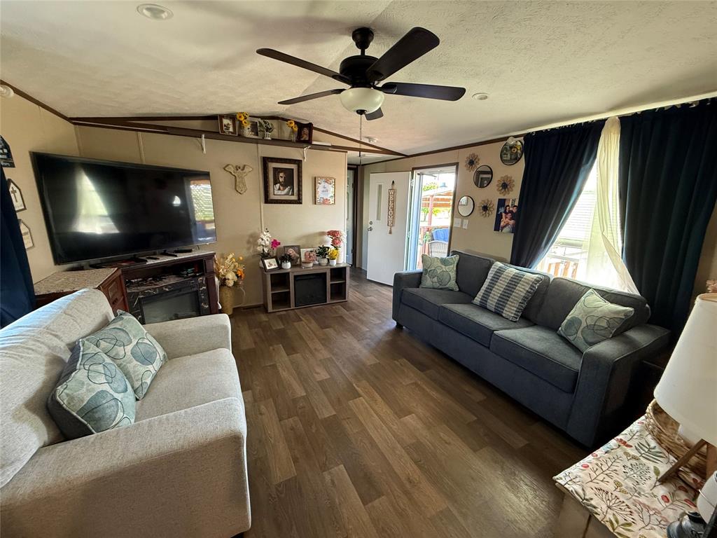 233 Overland Trail Jacksboro, TX 76458 - Photo 5 of 10 a living room with furniture and a flat screen tv with wooden floor