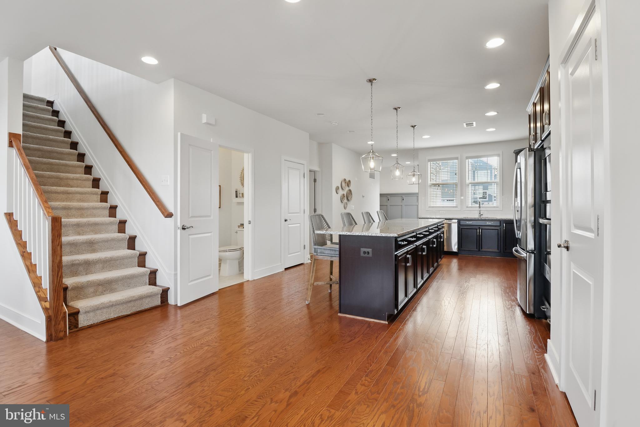 1010 Coubertin Drive Southeast Leesburg, VA 20175 - Photo 14 of 44 a kitchen with stainless steel appliances refrigerator a stove top oven with wooden floors