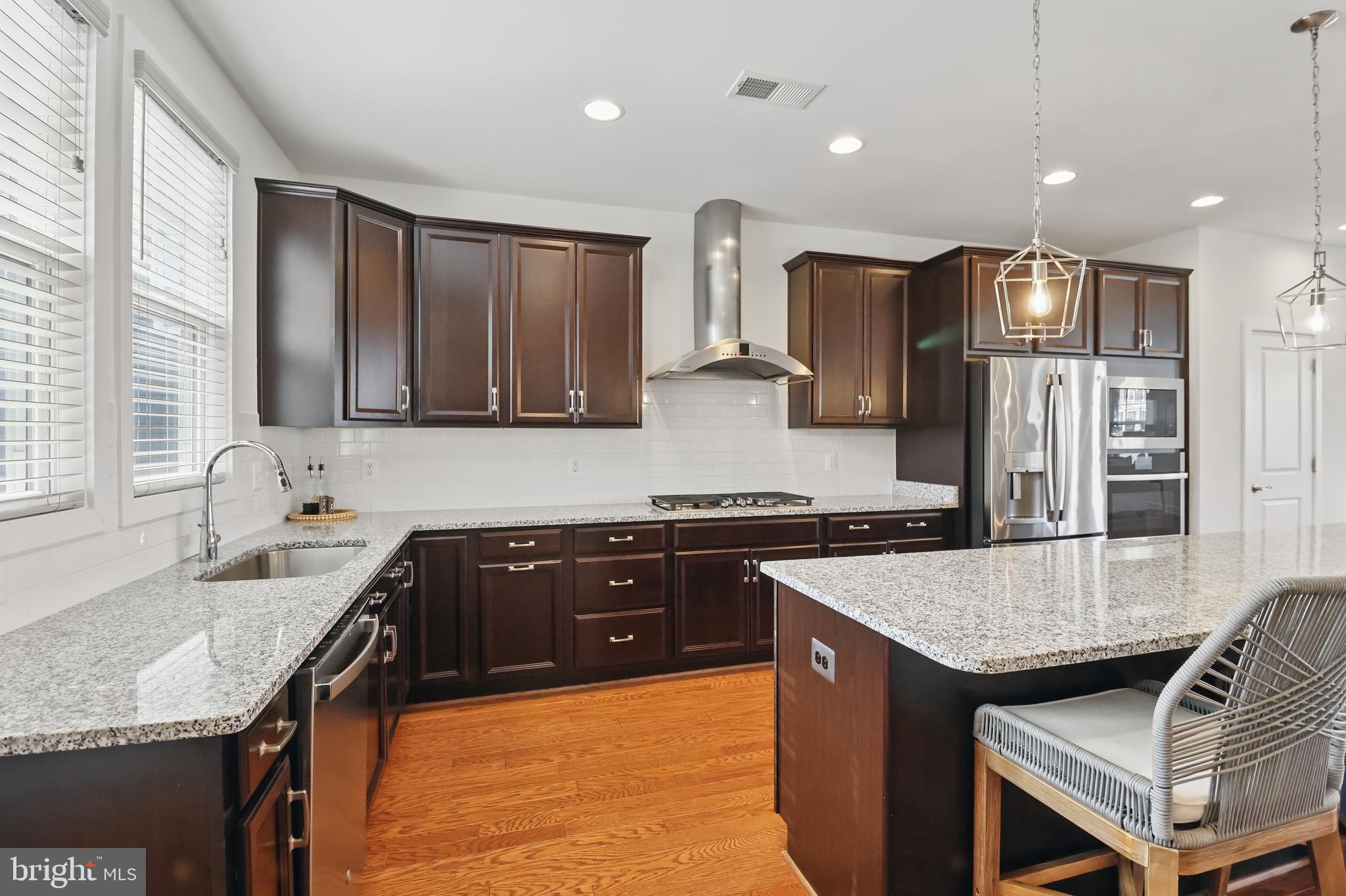 1010 Coubertin Drive Southeast Leesburg, VA 20175 - Photo 15 of 44 a kitchen with stainless steel appliances granite countertop a sink stove and refrigerator