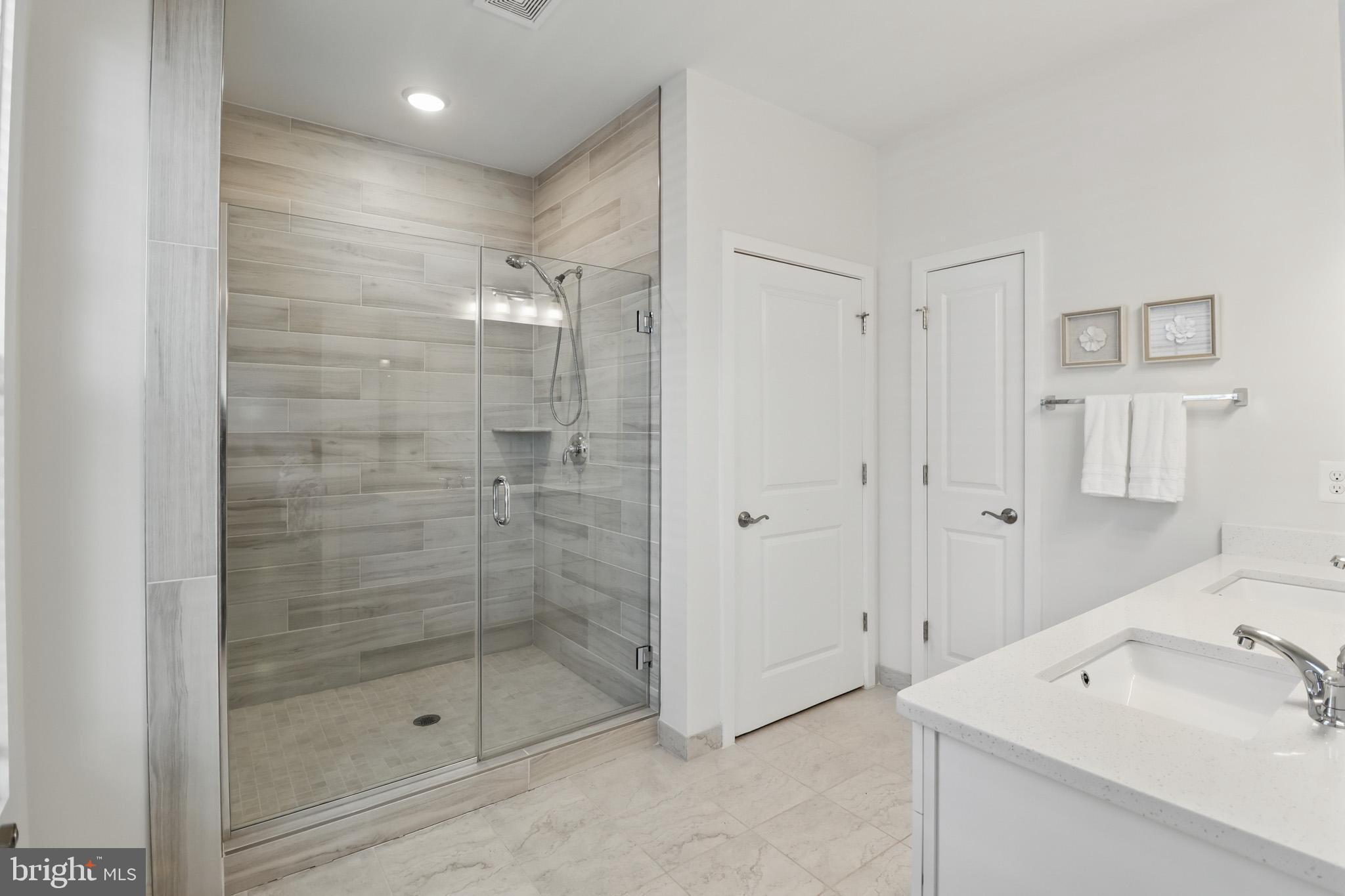 1010 Coubertin Drive Southeast Leesburg, VA 20175 - Photo 24 of 44 a bathroom with a shower and a sink