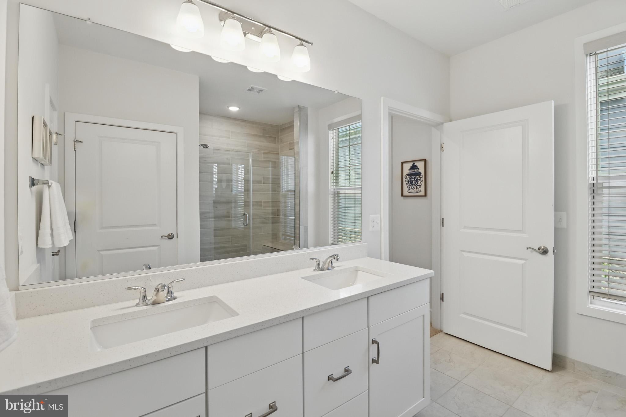 1010 Coubertin Drive Southeast Leesburg, VA 20175 - Photo 25 of 44 a bathroom with a double vanity sink and a mirror