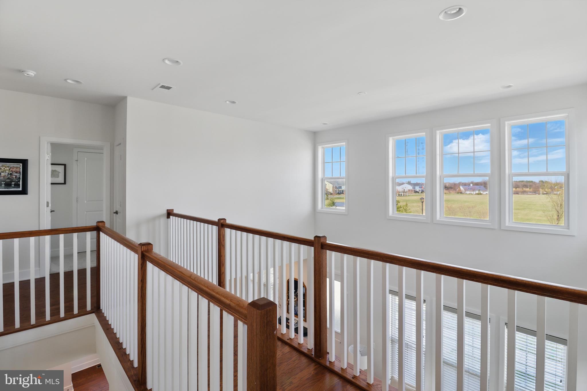 1010 Coubertin Drive Southeast Leesburg, VA 20175 - Photo 27 of 44 a view of staircase with wooden floor and windows