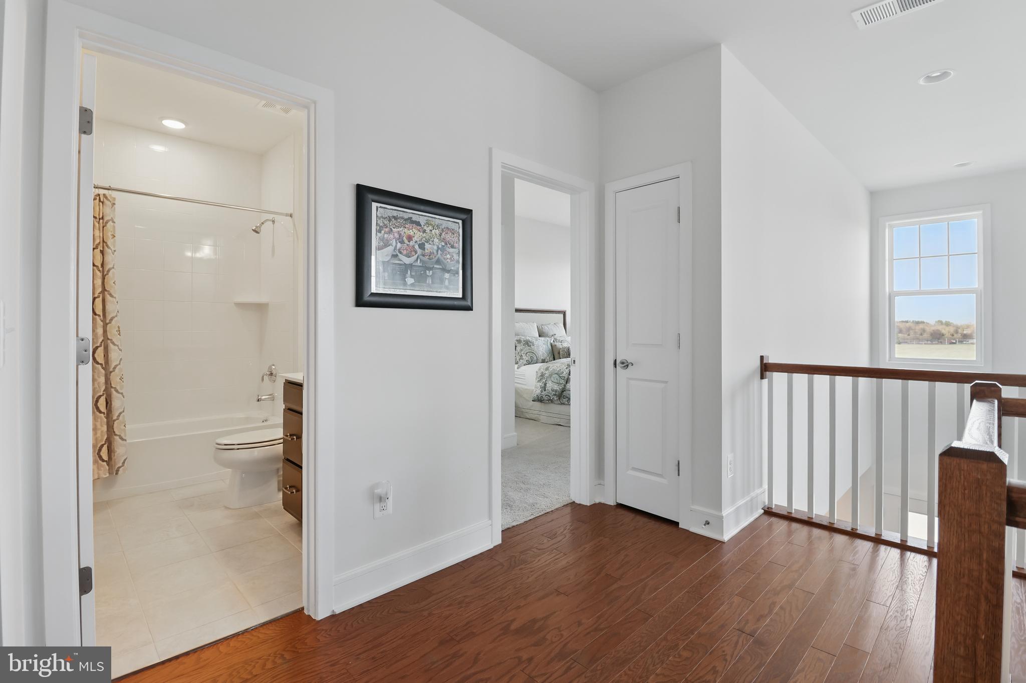 1010 Coubertin Drive Southeast Leesburg, VA 20175 - Photo 28 of 44 a view of an empty room with wooden floor and a bathroom