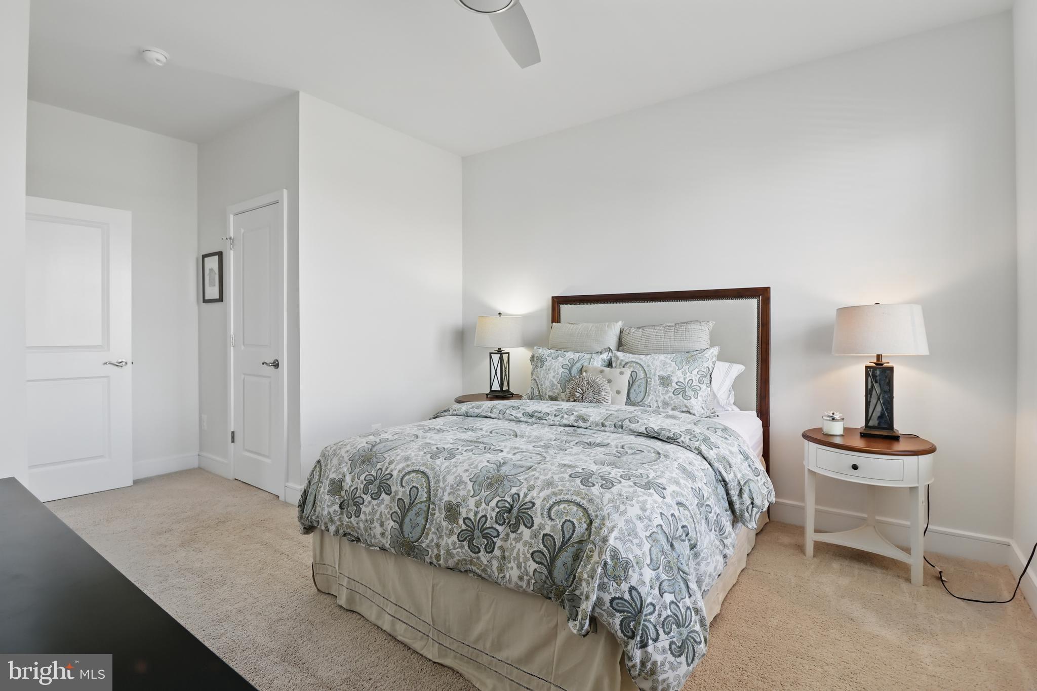 1010 Coubertin Drive Southeast Leesburg, VA 20175 - Photo 29 of 44 a bedroom with a bed and a lamp