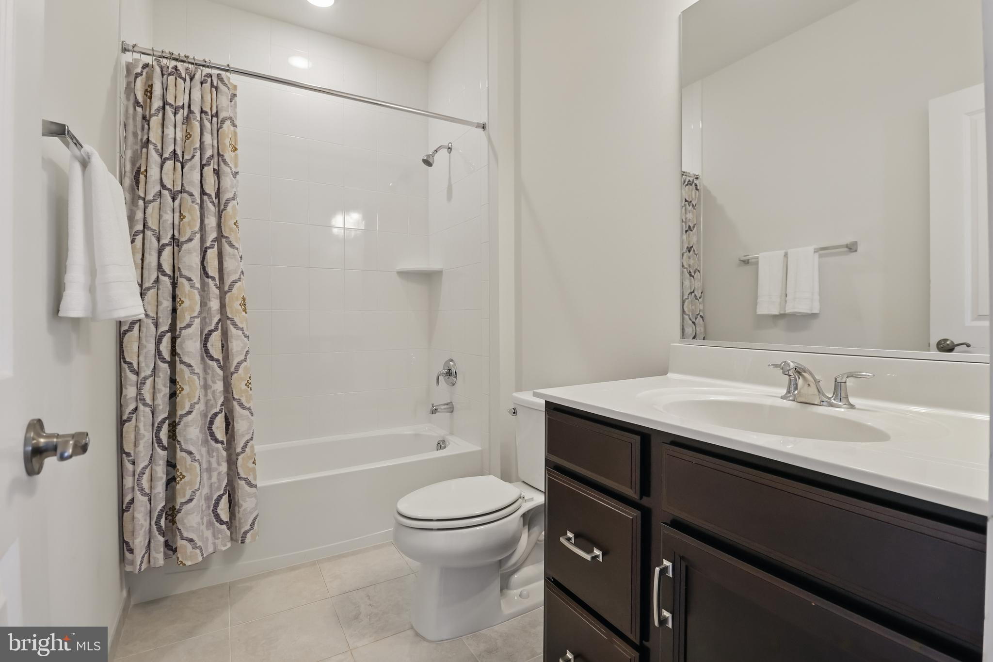 1010 Coubertin Drive Southeast Leesburg, VA 20175 - Photo 31 of 44 a bathroom with a granite countertop sink a toilet and shower