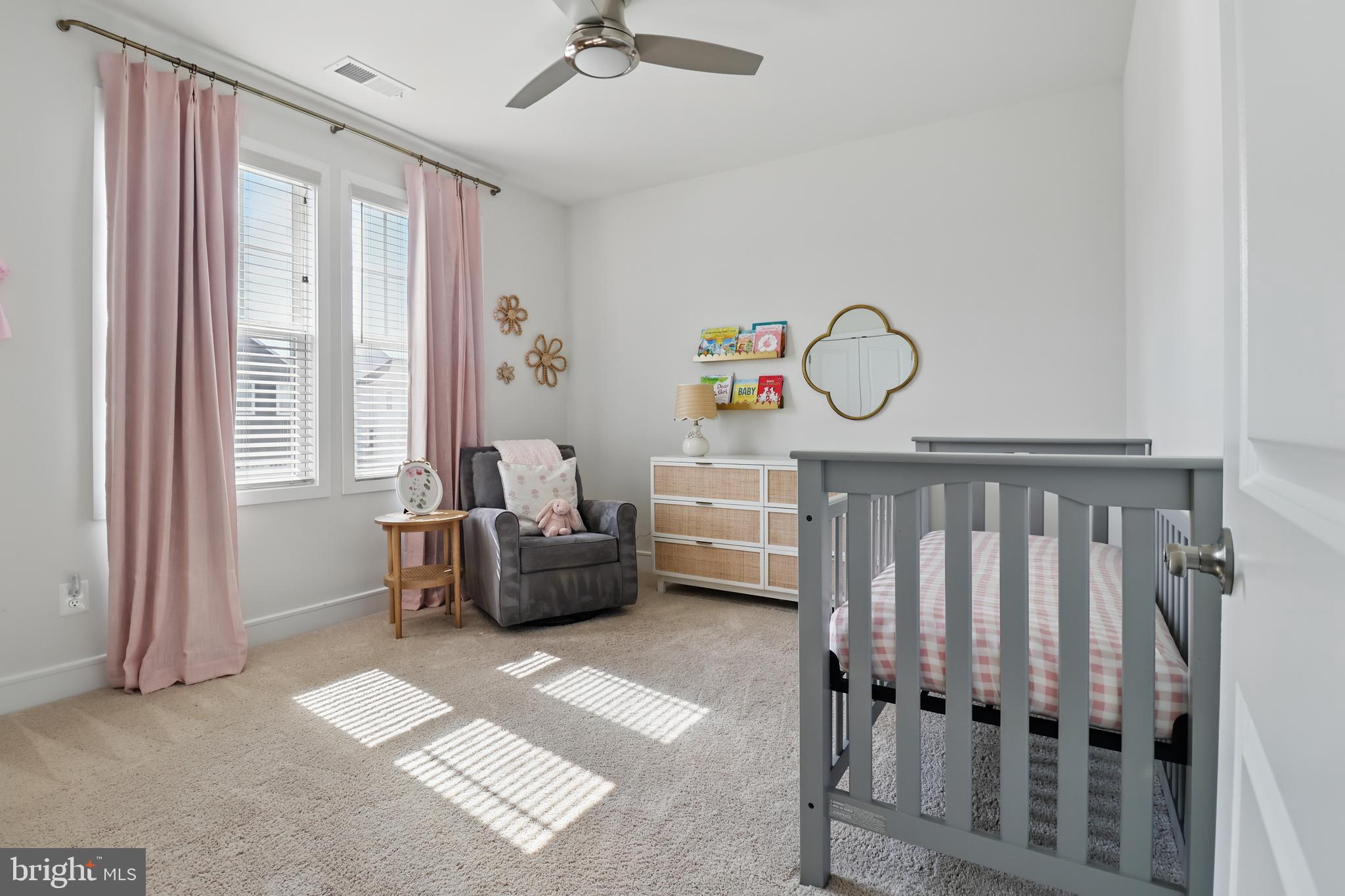 1010 Coubertin Drive Southeast Leesburg, VA 20175 - Photo 32 of 44 a living room with furniture a window and a chandelier