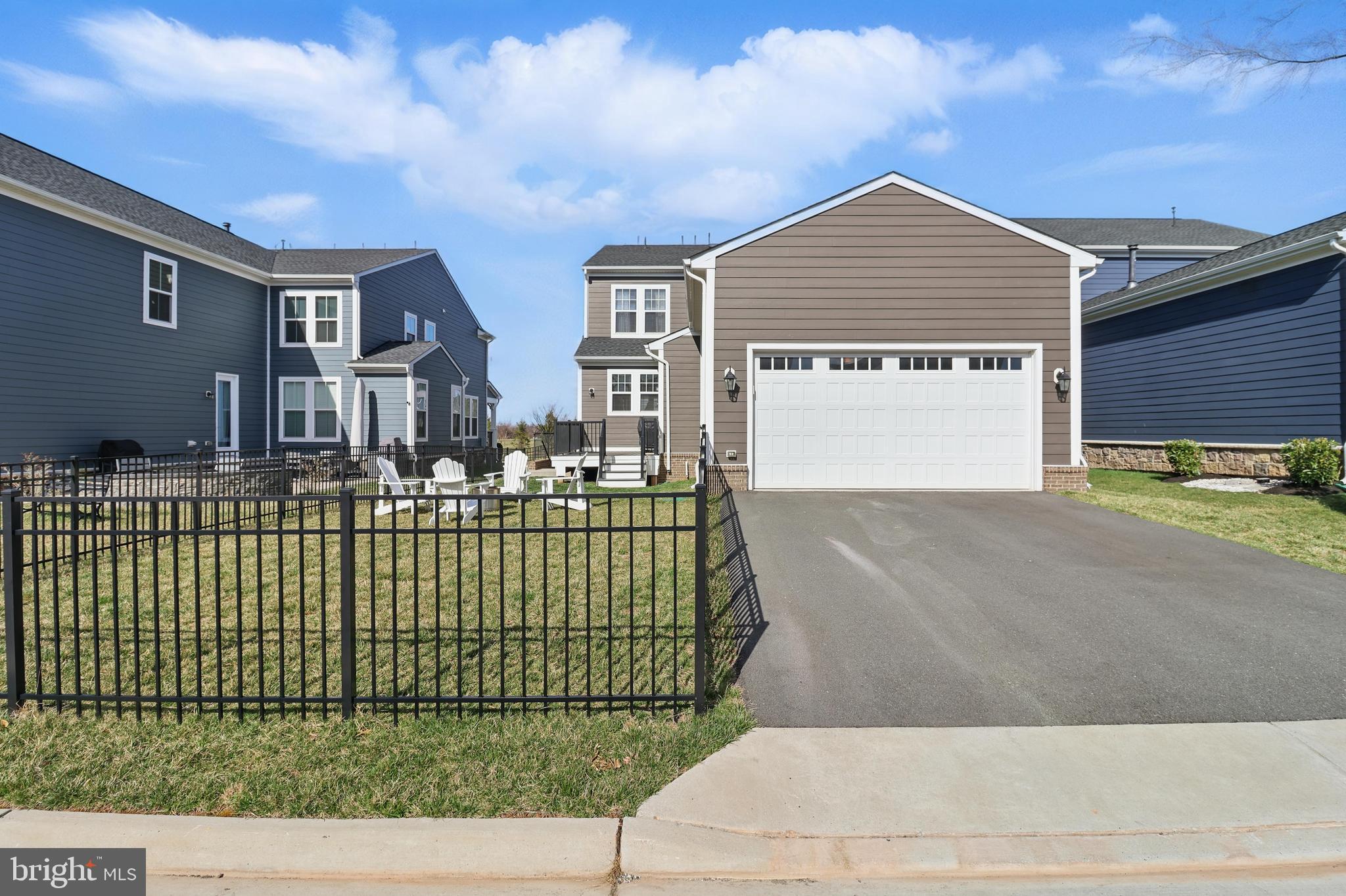 1010 Coubertin Drive Southeast Leesburg, VA 20175 - Photo 42 of 44 a front view of a house with a garden