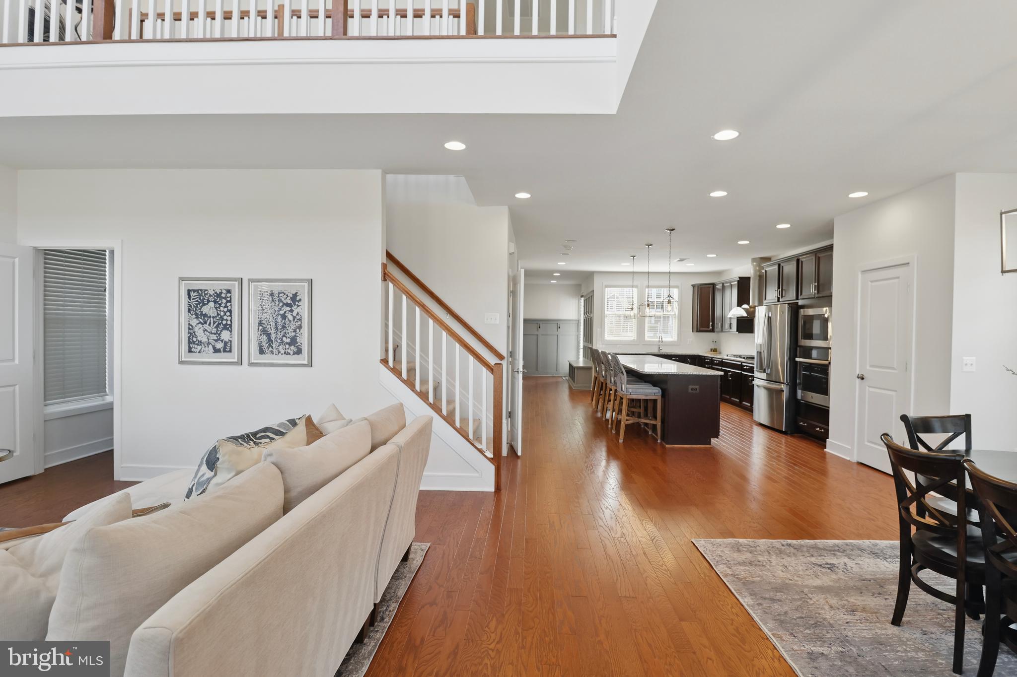1010 Coubertin Drive Southeast Leesburg, VA 20175 - Photo 6 of 44 a living room with furniture and kitchen view with wooden floor