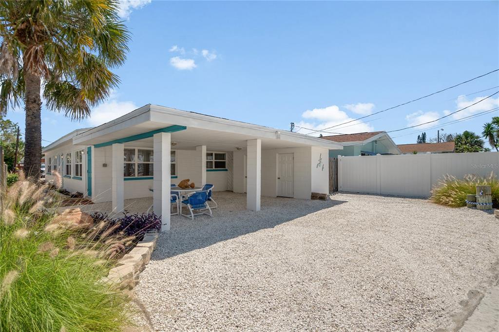13440 1st Street East Madeira Beach, FL 33708 - Photo 8 of 44 a front view of a house with a patio