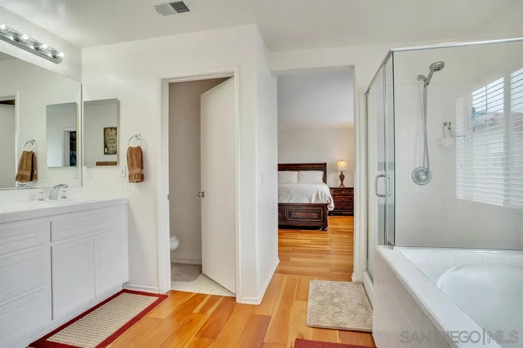 1103 Greenway Road Oceanside, CA 92057 - Photo 13 of 25 a bathroom with a sink a mirror and a shower