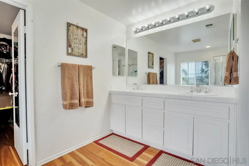 1103 Greenway Road Oceanside, CA 92057 - Photo 14 of 25 a bathroom with a sink and a mirror