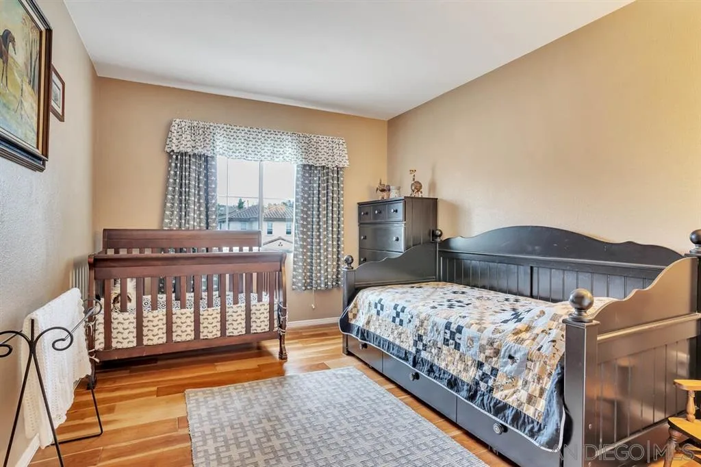 1103 Greenway Road Oceanside, CA 92057 - Photo 15 of 25 a bedroom with a bed and a table in it