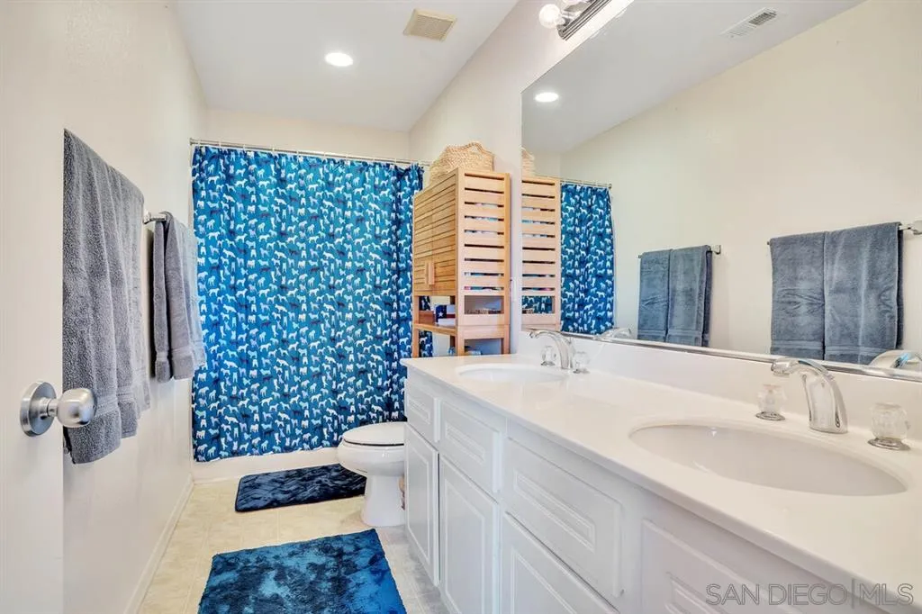 1103 Greenway Road Oceanside, CA 92057 - Photo 16 of 25 a bathroom with a sink a toilet and shower
