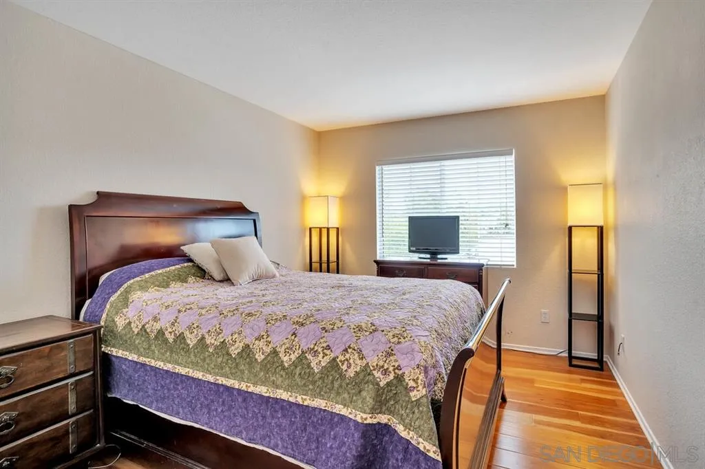 1103 Greenway Road Oceanside, CA 92057 - Photo 17 of 25 a bedroom with a bed and wooden floor