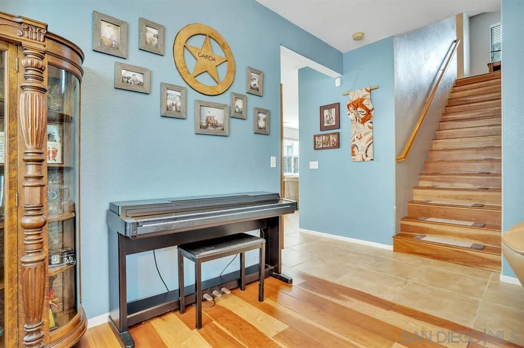 1103 Greenway Road Oceanside, CA 92057 - Photo 4 of 25 a view of a hallway with entryway wooden floor and front door
