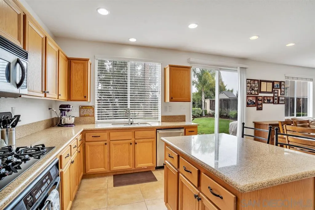 1103 Greenway Road Oceanside, CA 92057 - Photo 5 of 25 a kitchen with stainless steel appliances granite countertop a sink stove and cabinets