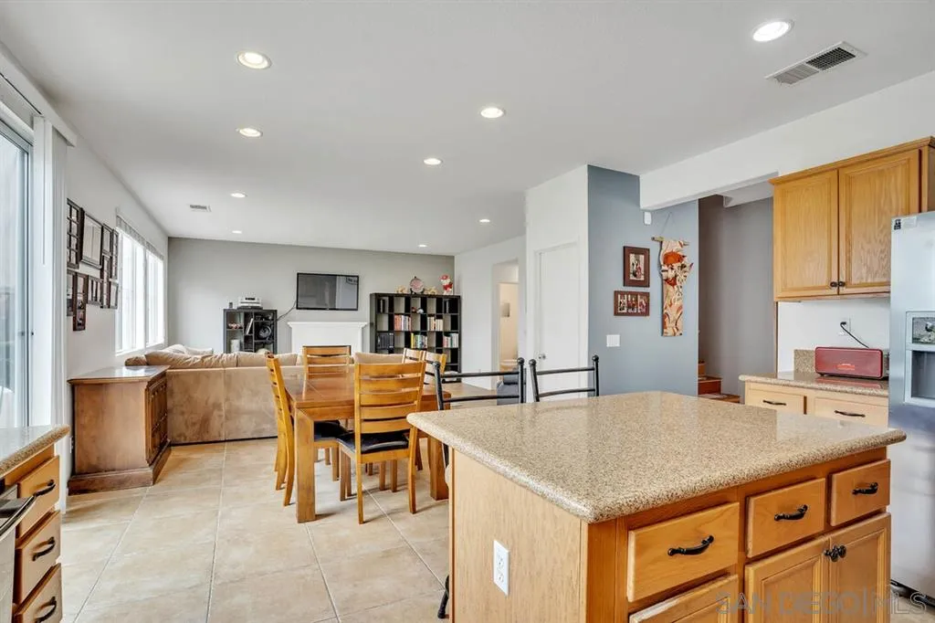 1103 Greenway Road Oceanside, CA 92057 - Photo 7 of 25 a living room with furniture and a kitchen