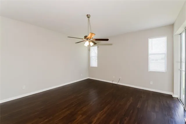 a view of a room with wooden floor and a window