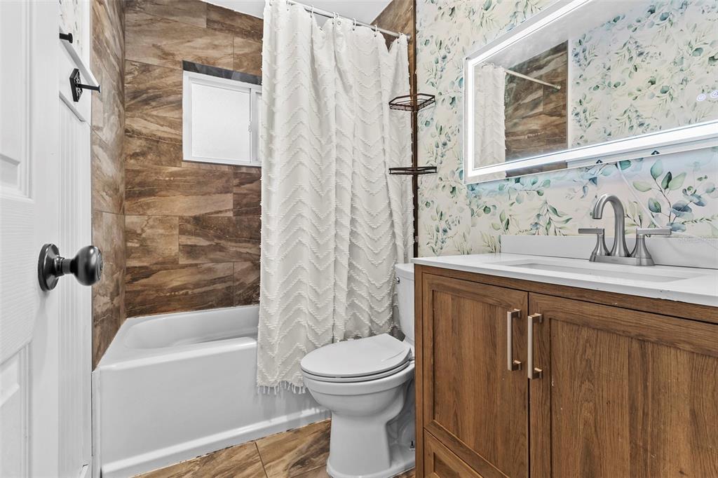 6221 Dalton Street Spring Hill, FL 34606 - Photo 6 of 40 a bathroom with a sink toilet and shower
